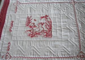 Close up of red work quilt quilting